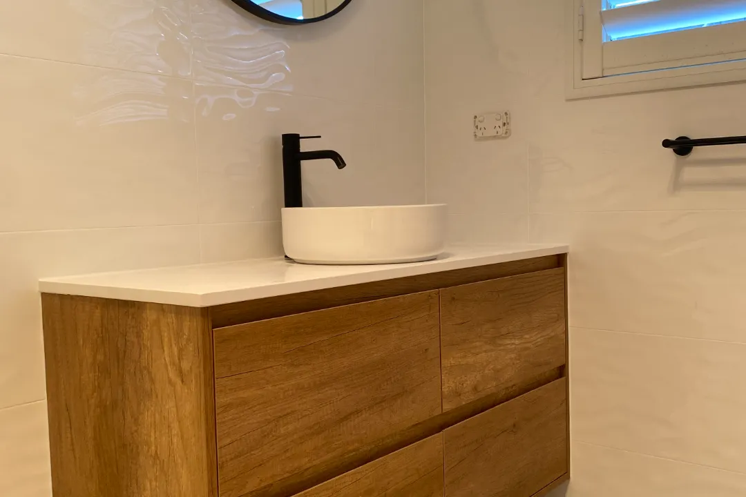 Bathroom Renovations Ellenbrook Timber-look vanity with white vessel basin and tall black mixer tap