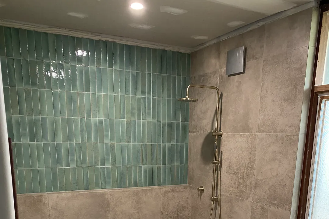 Bathroom Renovations Ellenbrook Shower with green vertical feature tiles and a brushed brass shower rail